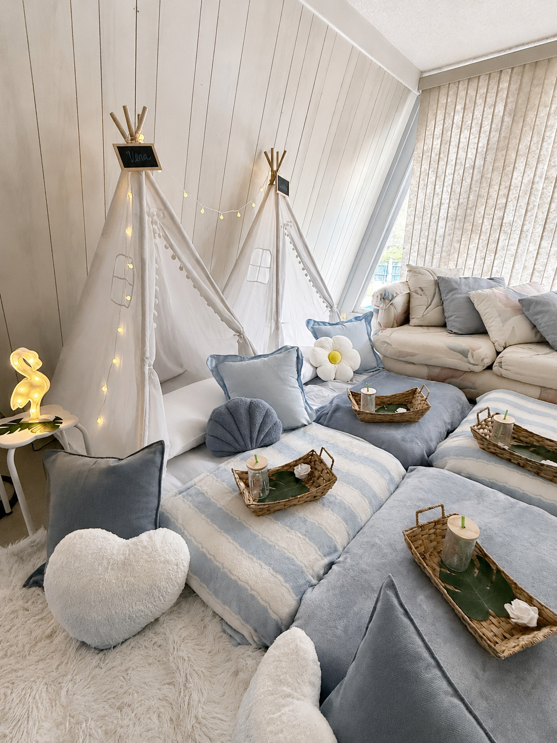 Soft blue cozy teepee party with wicker trays